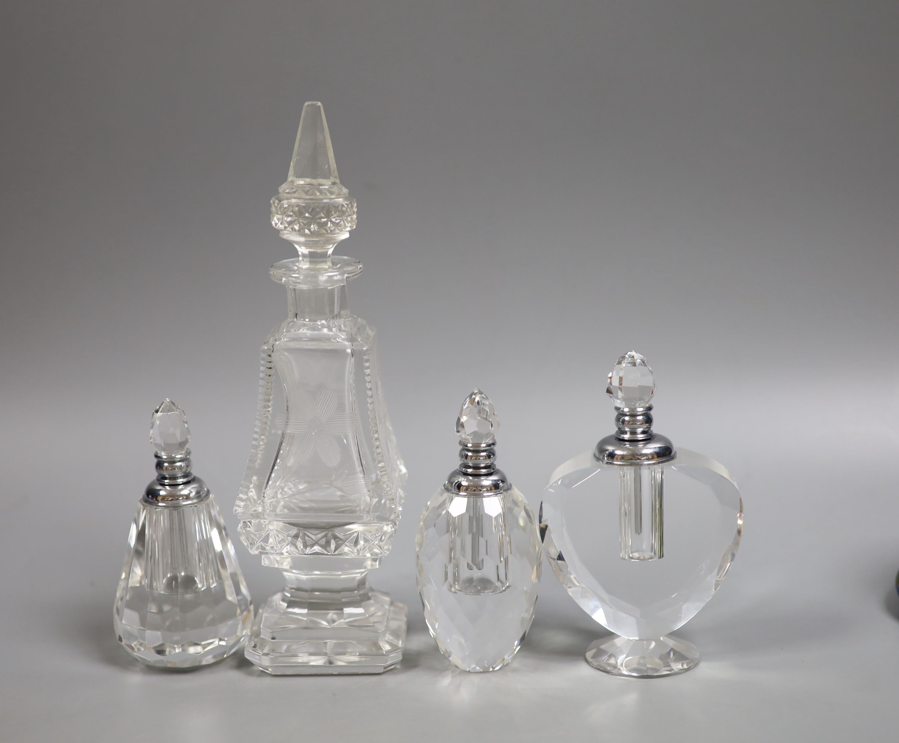 A collection of various glass scent bottles including a Lalique flower scent bottle and Bohemian examples, tallest 20.5cm